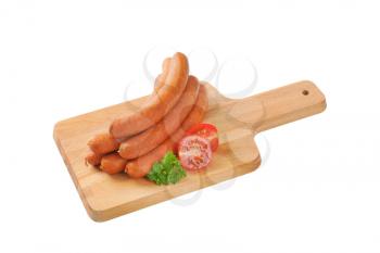 stack of long thin sausages on cutting board