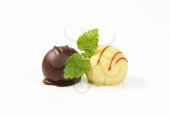 two belgian chocolate pralines on white background