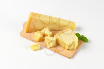 pieces of parmesan cheese on wooden cutting board