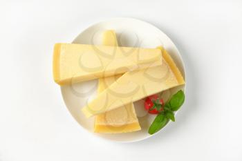 three wedges of parmesan cheese on white plate
