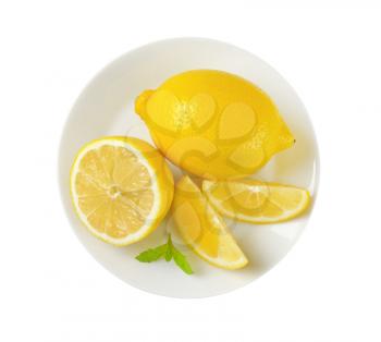 plate of whole and sliced lemons