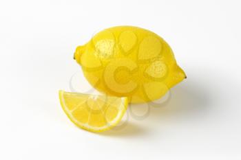 whole fresh lemon and wedge