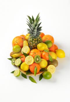 plate of fresh tropical fruit on white background