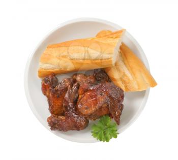 sweet and spicy BBQ chicken wings served  with white French bread