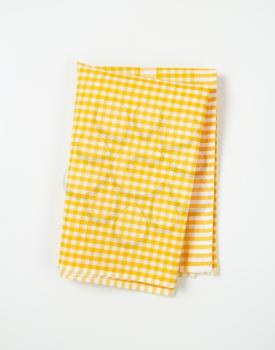 yellow and white checkered tea towel on white background