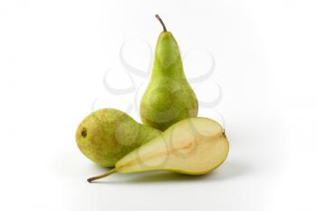 two whole fresh green pears and one half