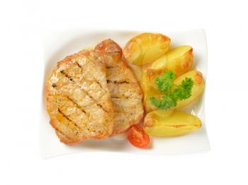 Grilled honey glazed pork chops with potato wedges