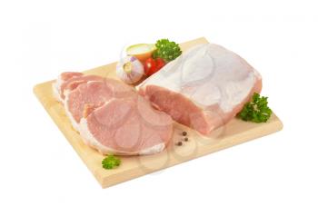 raw boneless pork loin chops on cutting board