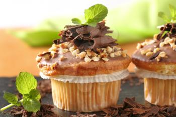Muffins with chocolate topping and chopped nuts