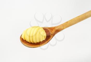 butter curl on wooden spoon