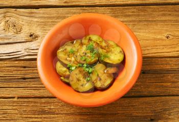 bowl of grilled zucchini on wooden background