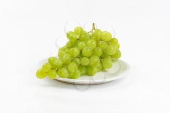 bunch of white grapes on white plate