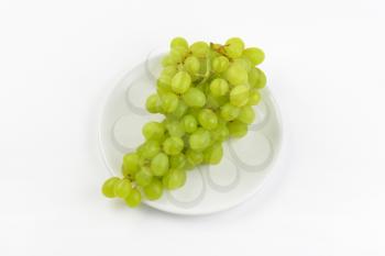 bunch of white grapes on white plate