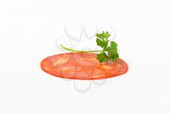 thin chorizo slice on white background