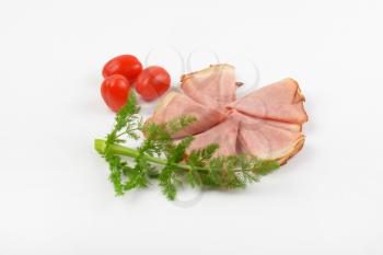 ham slices with fresh dill and cherry tomatoes on white background