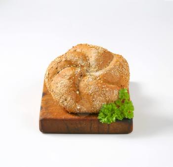 two whole wheat buns on wooden cutting board