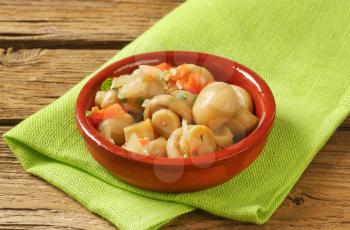 bowl of pickled champignons on green place mat