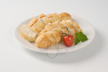 sliced french baguette on white plate