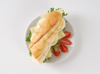 sandwich with eggs and cheese on white plate