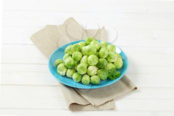 plate of raw Brussels sprouts on beige place mat