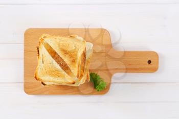 stack of toasted bread slices on wooden cutting board