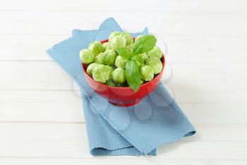 bowl of raw Brussels sprouts on blue place mat