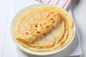 Stack of thin crepes on plate