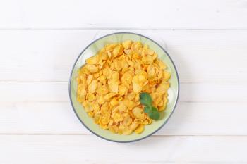 plate of corn flakes on white background