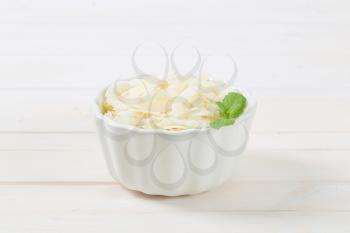 bowl of coconut chips on white background