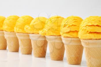 Yellow ice cream cones arranged in a row