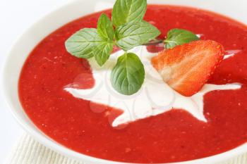 Bowl of chilled strawberry soup with cream