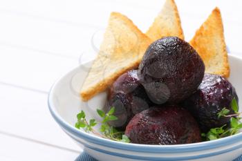 bowl of baked whole beet with toast - close up