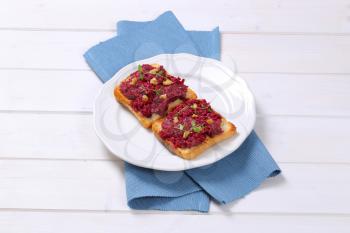 toast with beetroot spread on white plate
