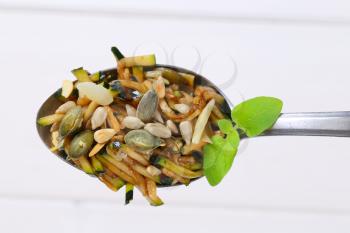Spoon of zucchini salad with seeds