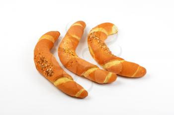 three fresh bread rolls on white background