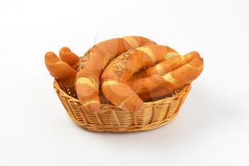 scuttle of fresh bread rolls on white background
