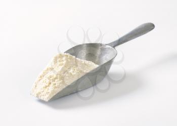 scoop of wheat flour on white background