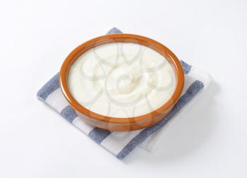 bowl of semolina pudding on striped napkin