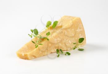 Wedge of Parmesan cheese on white background