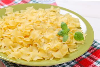 plate of quadretti - square shaped pasta on checkered place mat - close up