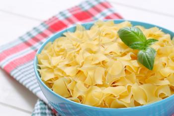bowl of quadretti - square shaped pasta on checkered place mat - close up