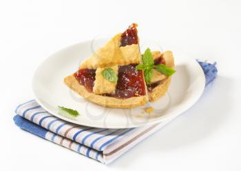 slices of strawberry jam tart  on white plate