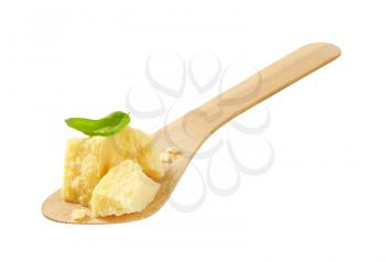 Pieces of Parmesan cheese on wooden spatula