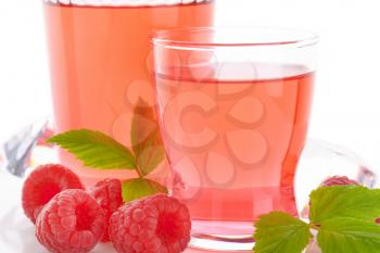 glasses of raspberry juice and fresh raspberries on white background - close up