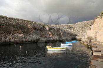 Empty boats in bay near Blue Grotto in Malta