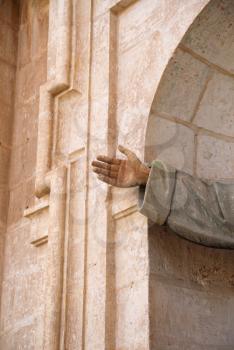 Detail of hand outstretched from a church alcove