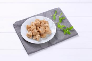 plate of soy meat cubes on grey place mat
