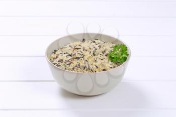 bowl of wild rice on white wooden background