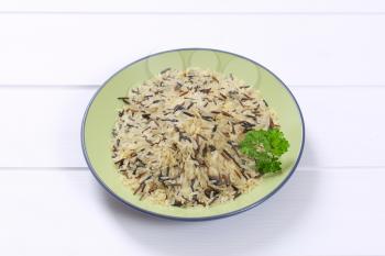 plate of wild rice on white wooden background