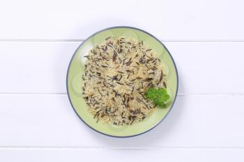plate of wild rice on white wooden background